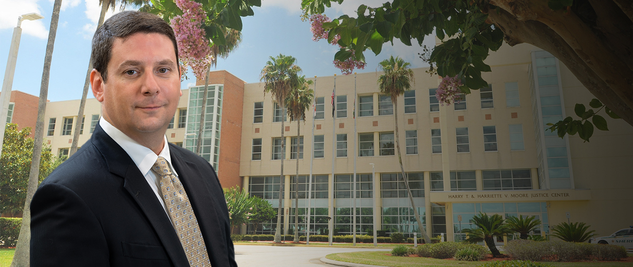 Jordan H. Kramer with the Harry T. and Harriette V. Moore Justice Center (Viera Courthouse) in the background.